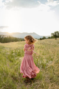 little girl spinning at photoshoot. photo taken at ute Vally park. Colorado family and engagement photography