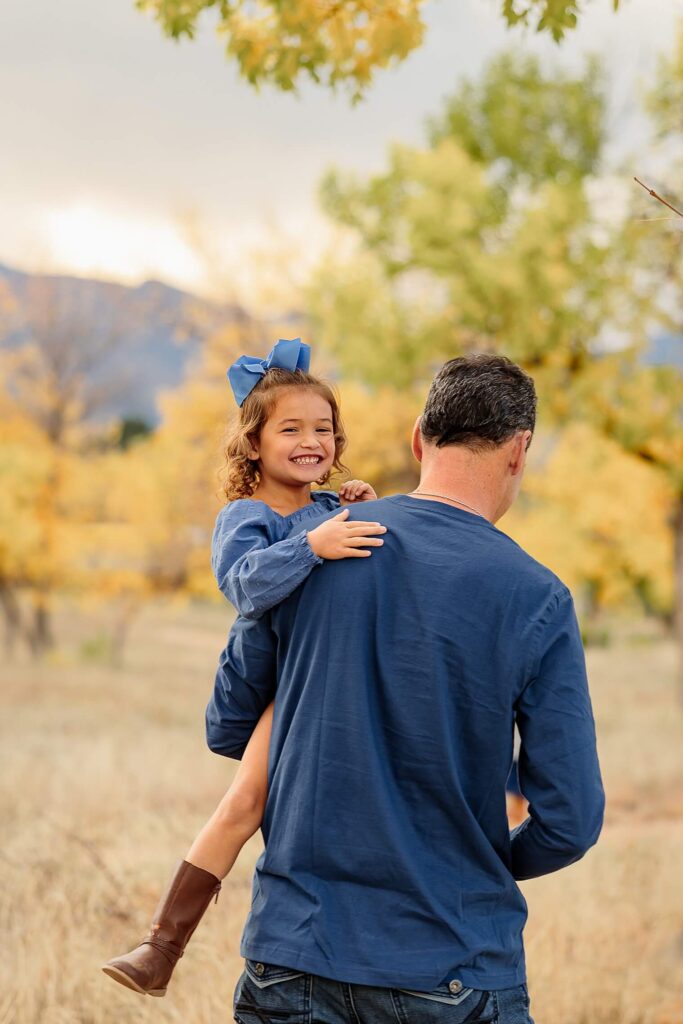 daughter being held by dad