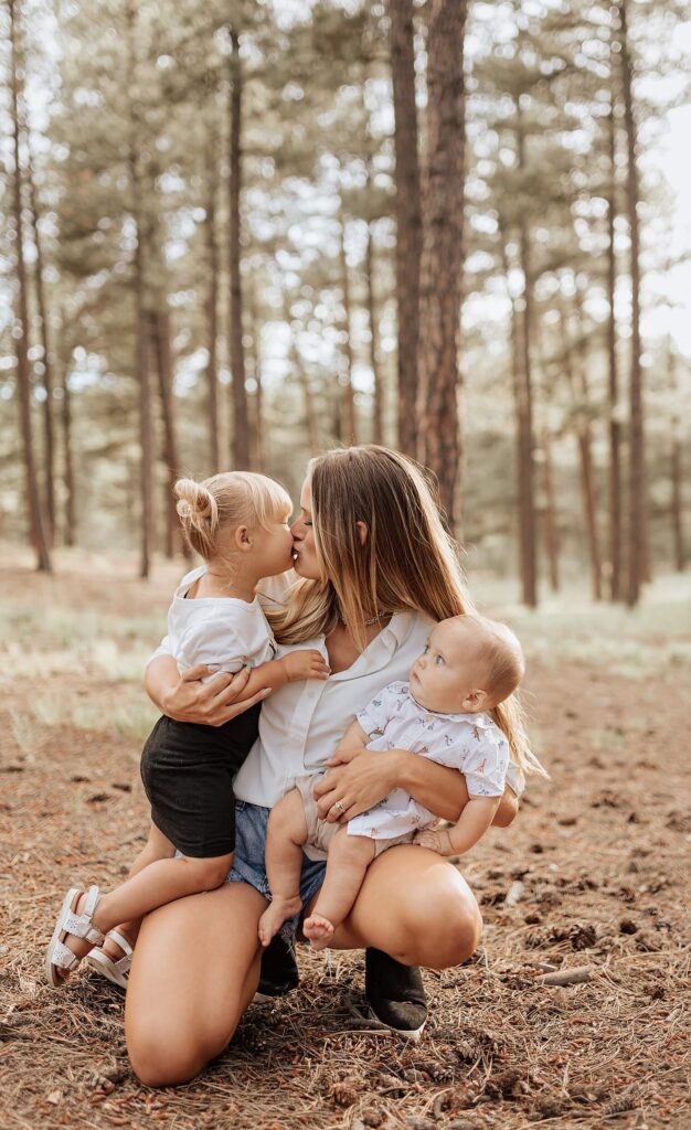 mom kissing her children