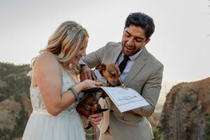 photo of couple having their dog sign wedding contract. Photo captured by Michelle Betz Photography