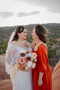 bride and mother smiling at each other at garden of the gods colorado springs