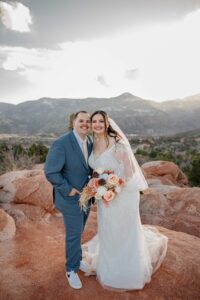 garden of the gods bride and groom portrait smiling the camera in wedding dress and tux