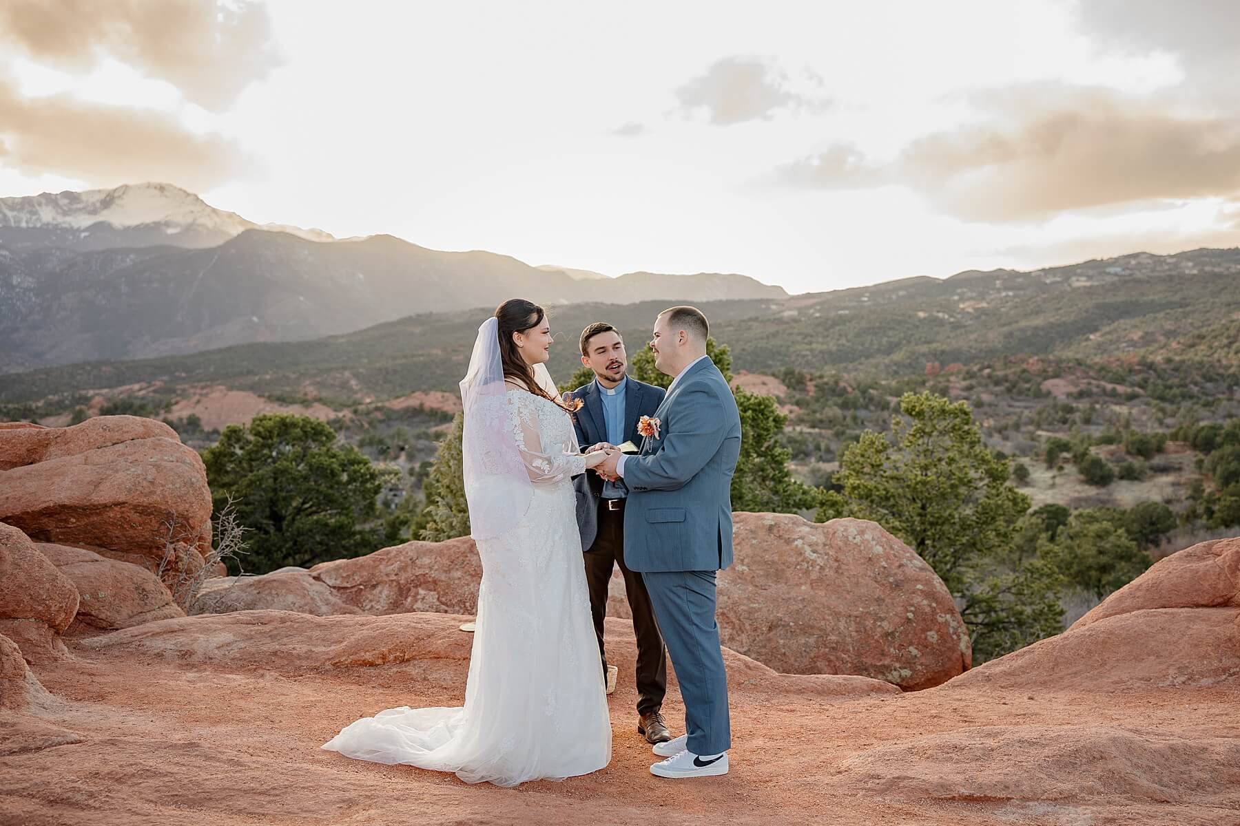 garden of the gods wedding bride and groom exchanging vows at sunset