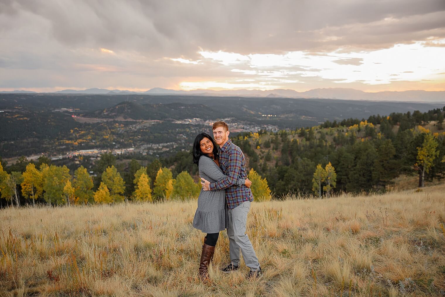 Colorado family and engagement photos. Gorgeous couple hugging in the mountains and fall. Captured by Michelle Betz Photography