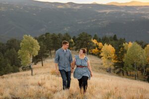 couple looking at each other smiling for their engagement photo in the fall. 