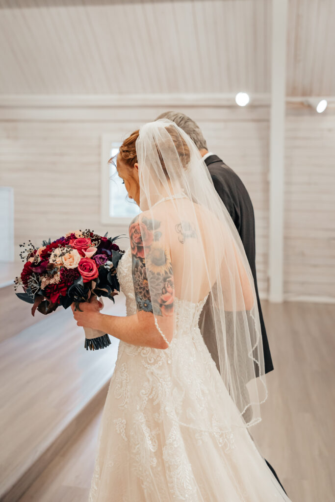 bride walking down aisle with father