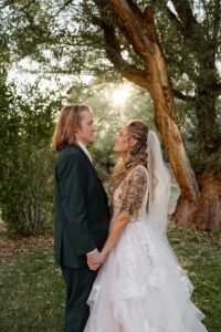 Colorado bride and groom portrait. They are holding hadns and looking at each other. Captured by Michelle Betz Photography