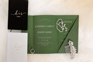 detail wedding shot with invitation, vows, jewelry, and rings. Captured at a colorado wedding venue 