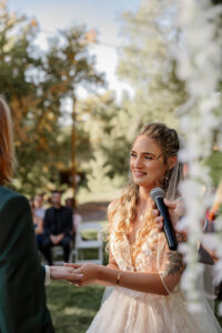 A ceremony photo of the bride putting the ring on her groom. Captured by Michelle Betz Photography