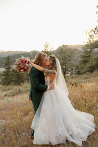 Bride and groom kissing. Surrounded by mountains. Captured by Colorado Springs Elopement Photographer, Michelle Betz