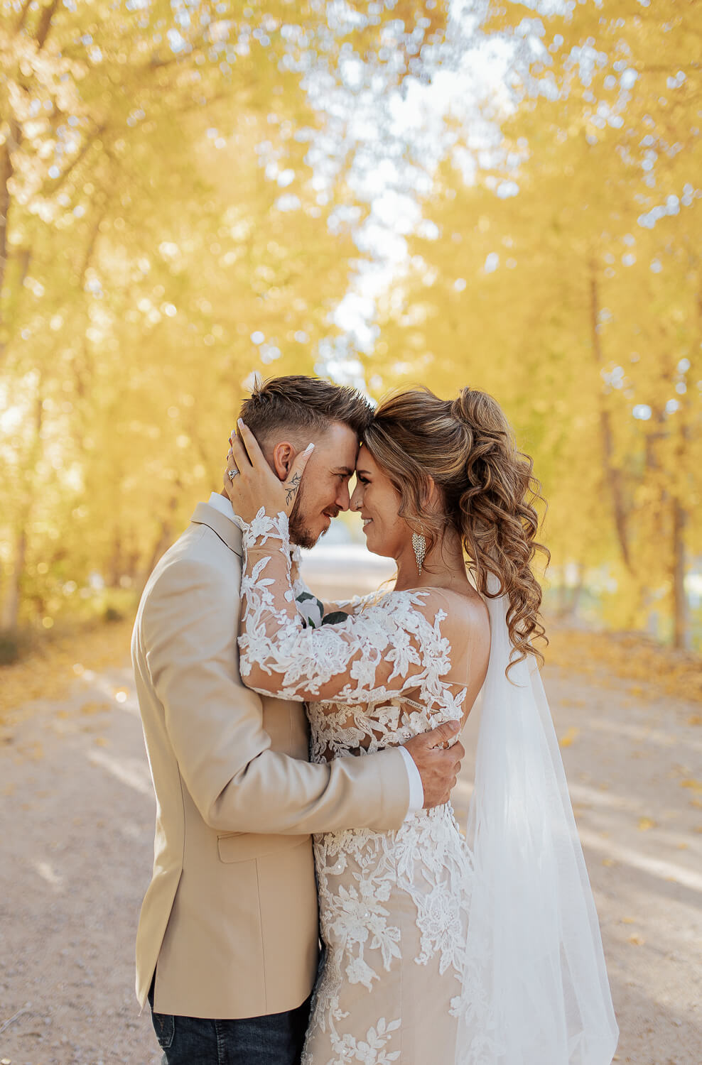 a bride and groom looking at each other and hugging. Captured by Michelle, a Colorado wedding photographer