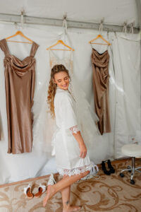 A bride in her getting ready gown, twirling and smiling down