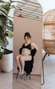 A mirror reflection image of a pregnant women. Captured by Michelle Betz Photography