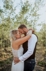 A couple posting for a wedding portrait. Surrounded by the Colorado Springs forest.